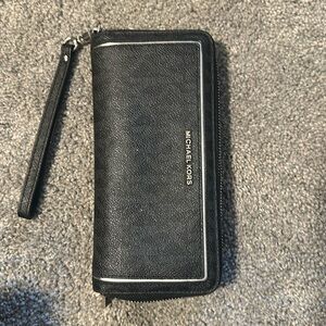 Michael Kors wallet, small white mark in the front.
